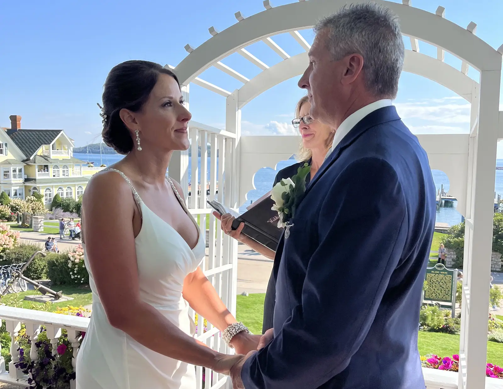 A photo of a wedding couple holding hands in front of the altar
