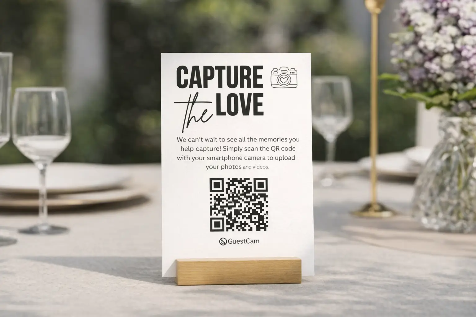 Table sign at a wedding reading ‘Capture the Love’ with a QR code for guests to scan and upload photos to a shared gallery