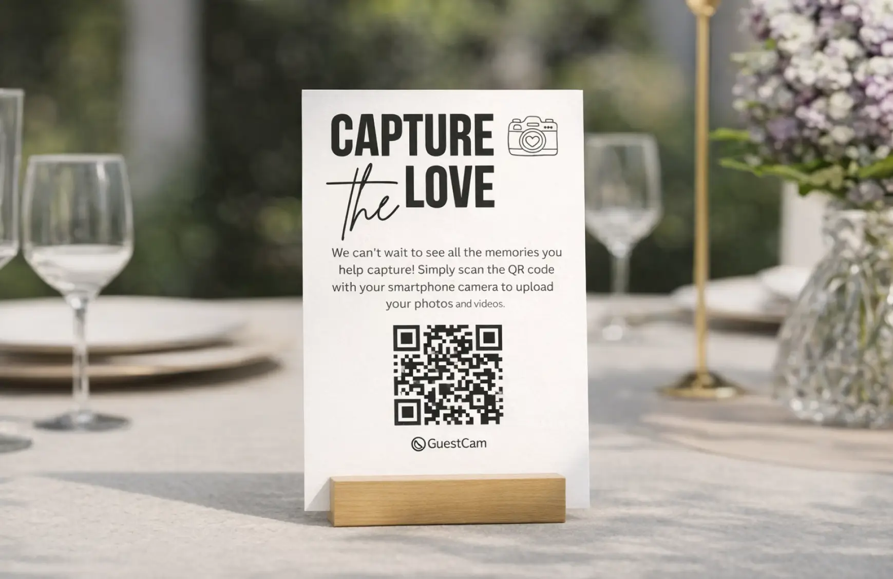 Wedding QR code sign on reception table for guests to share photos and videos instantly.