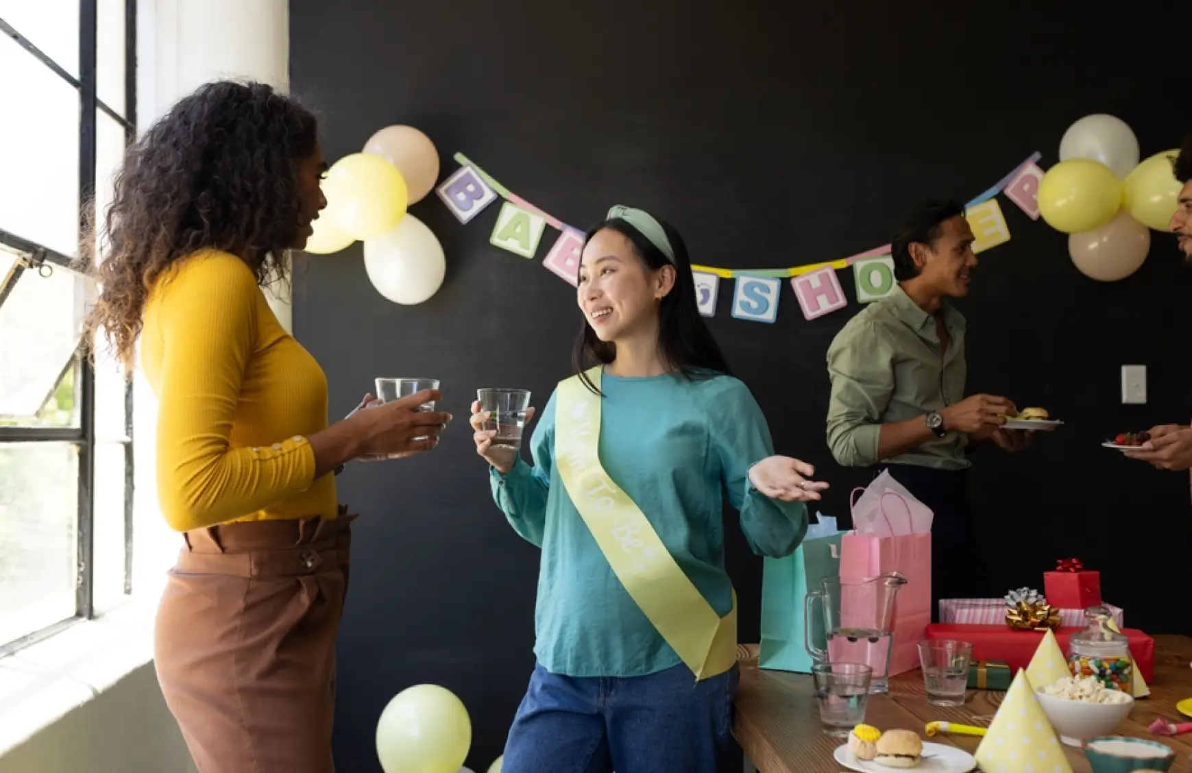 Baby shower guests mingling with the mom-to-be — the kind of moment an audio guestbook captures beyond photos alone.