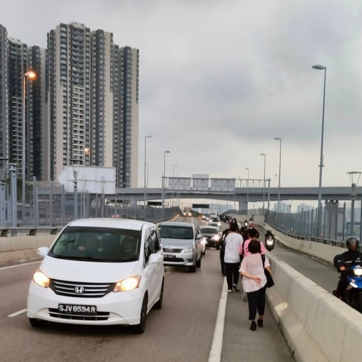 With bus drivers on strike, Malaysians commuting to Singapore walk across the border to get to work
