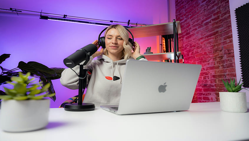 female entrepreneur creating online videos at her workspace