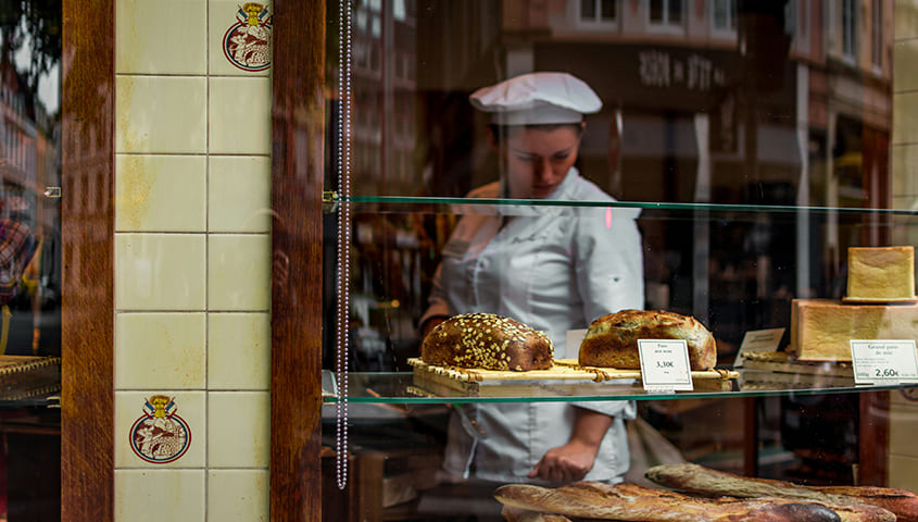 woman displaying freshly baked bread, illustrating business ideas for women