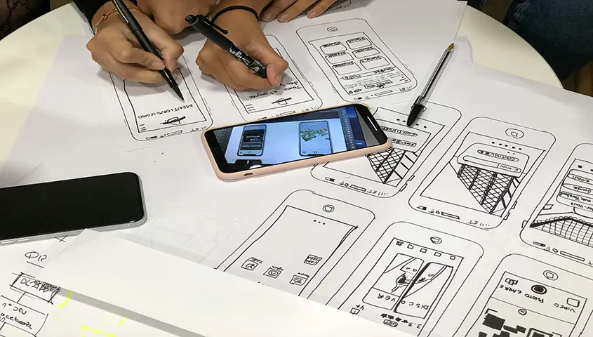 woman creating a mobile application at her workspace for business ideas for women
