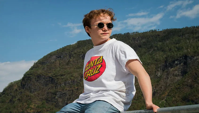 man wearing sunglasses and a t-shirt with front print showing design size for shirts
