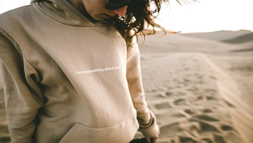 woman is wearing an eco-friendly hoodie made of friendly materials.
