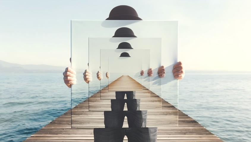 infinite wooden pier with repeating hat silhouettes on transparent panels over sea