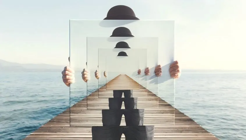 infinite wooden pier with repeating hat silhouettes on transparent panels over sea