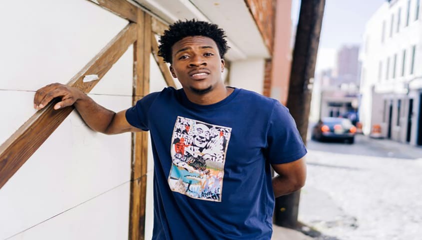 Man is wearing a custom t-shirt that he bought from Etsy's print-on-demand service.