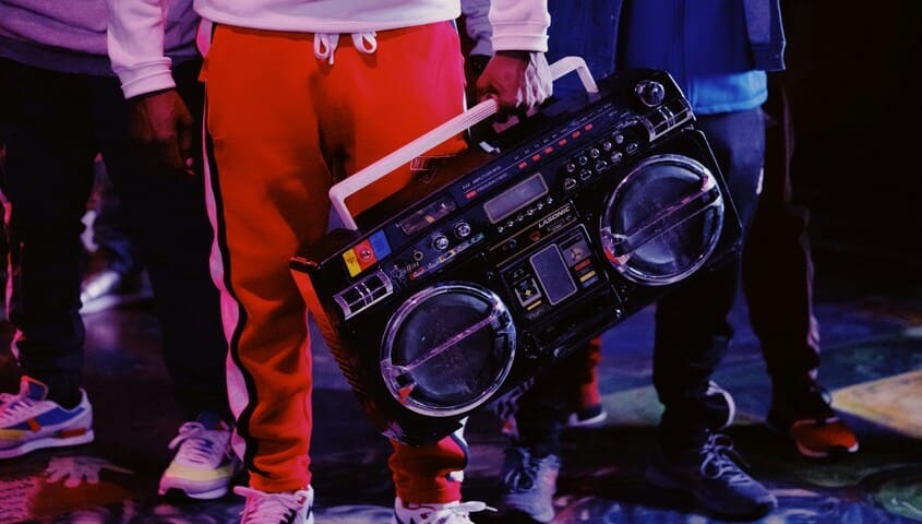People in 1980s hip hop style with a boombox