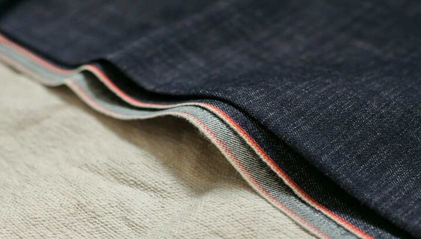 Denim fabric weave showing a durable, structured type of fabric used in clothing.