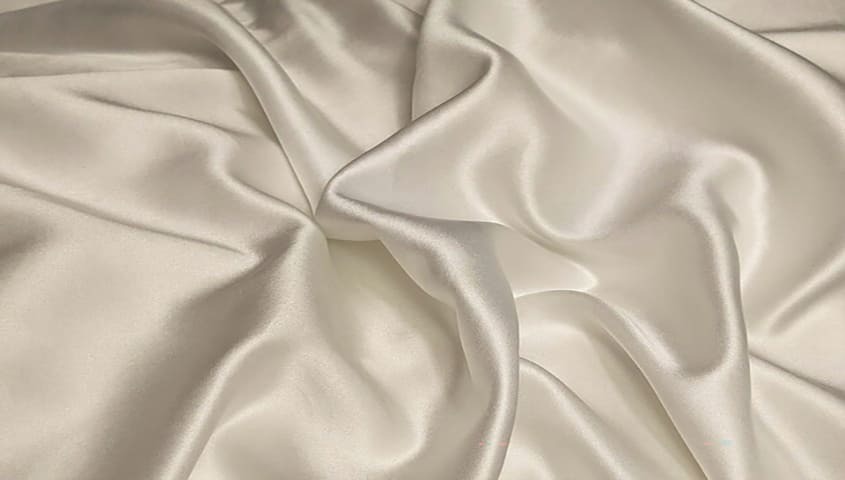Silk fabric with a smooth, glossy drape showing a luxury type of fabric in clothing.