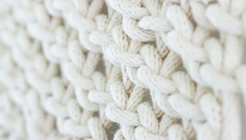 Wool fabric knit texture illustrating a warm, insulating type of fabric used in apparel.