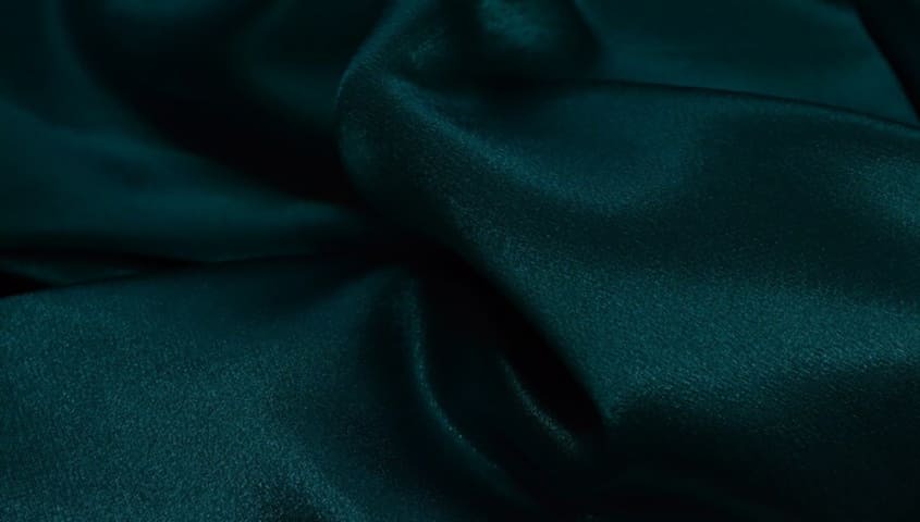 Satin fabric with a smooth, glossy finish, one of the common types of fabric used in apparel.