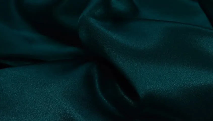 Satin fabric with a smooth, glossy finish, one of the common types of fabric used in apparel.