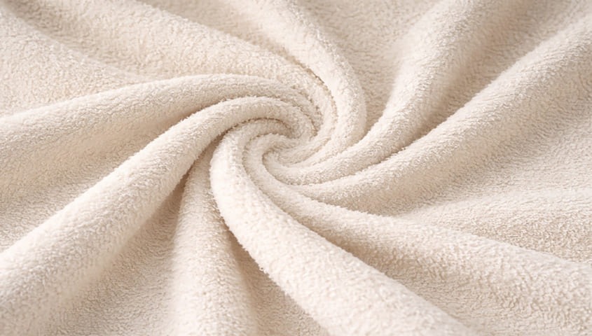 Terry fabric with looped, absorbent surface, one of the common types of fabric used for towels and loungewear.