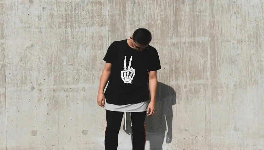 Fashion model wearing a graphic t-shirt, representing products sold through wix website building ecommerce stores.