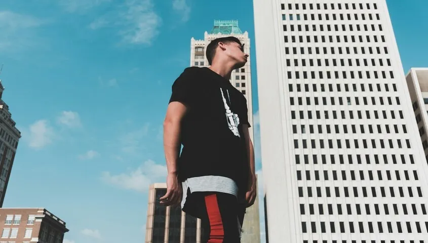 A creator wearing a custom streetwear piece, demonstrating how to design t-shirts that fit into a modern urban lifestyle and brand aesthetic.