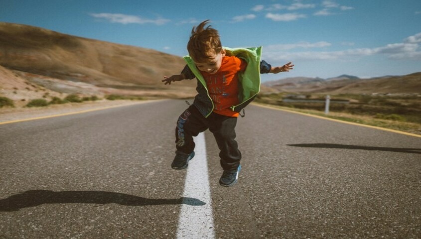 Child wearing bold layered clothing inspired by 90s fashion trends and retro kids 90s outfits