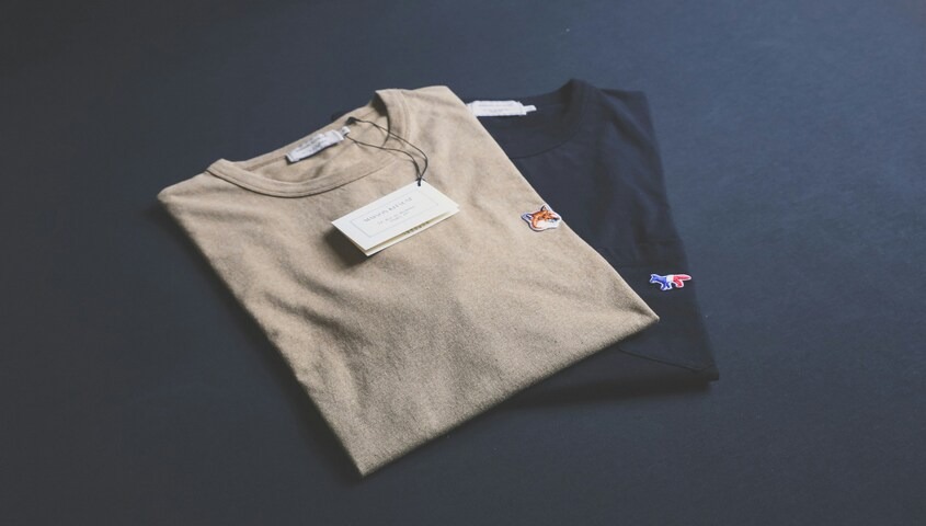 Minimalist folded T-shirts shown as most profitable products to sell online and scalable e-commerce products for fashion brands.