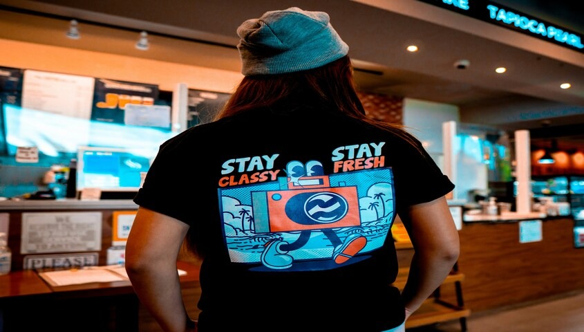 Woman wearing a graphic tee with a colorful back print, one of the most popular different types of t-shirts for self-expression