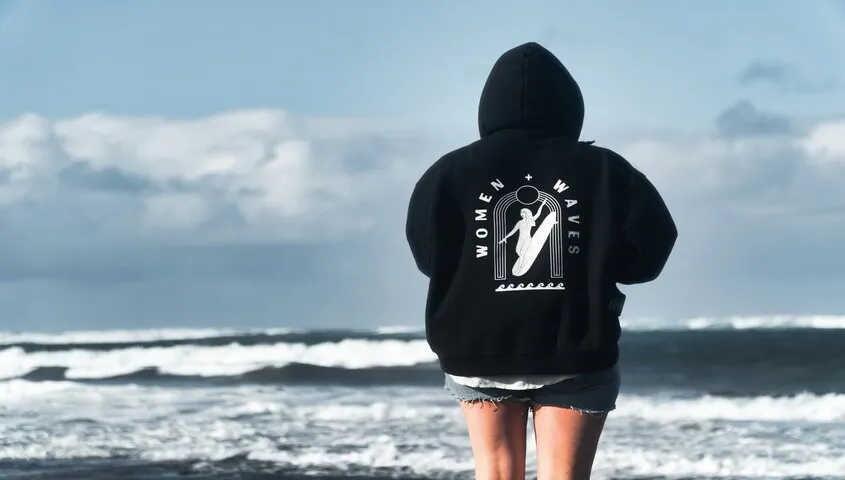 Oversized back print hoodie design on a black custom hoodie — bold graphic placement for clothing brands