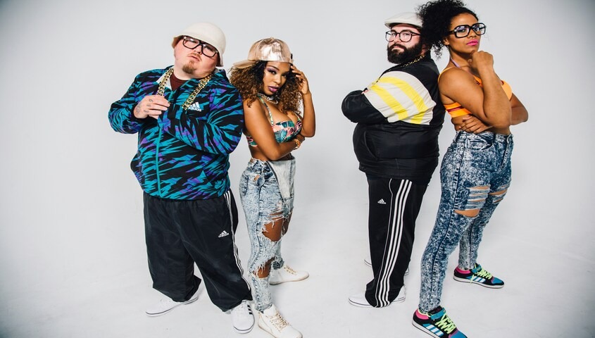 Group in tracksuits, acid-washed jeans, gold chains and oversized fits showing what people wore in the 90s