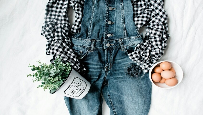 Denim overalls with gingham shirt flatlay, western 70s style with prairie influence