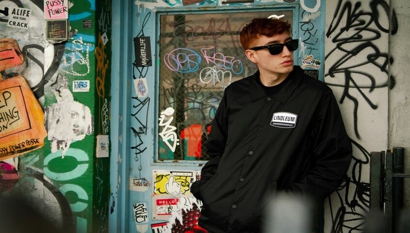 Streetwear product photo against a graffiti backdrop, an example of strong photography for SEO on Etsy