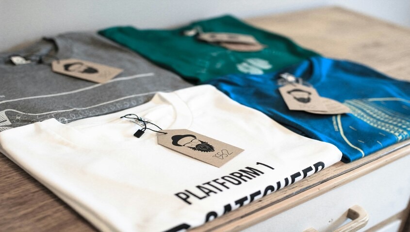 Folded custom t-shirts with hang tags, one of the top business ideas for teens.