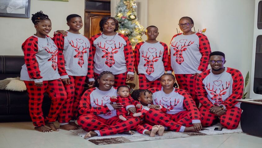 Extended family posed in matching red plaid outfits, showing that the best family reunion shirt ideas are half concept and half execution.