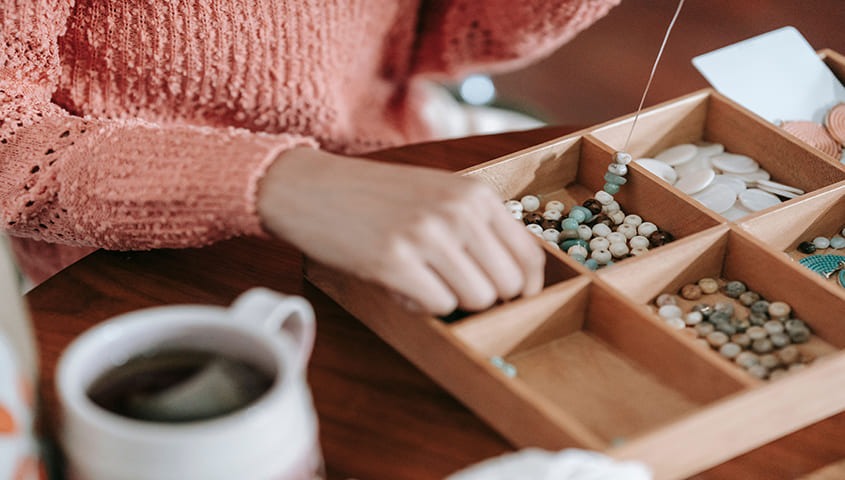 Woman is DIY custom jewelry as personalized gift