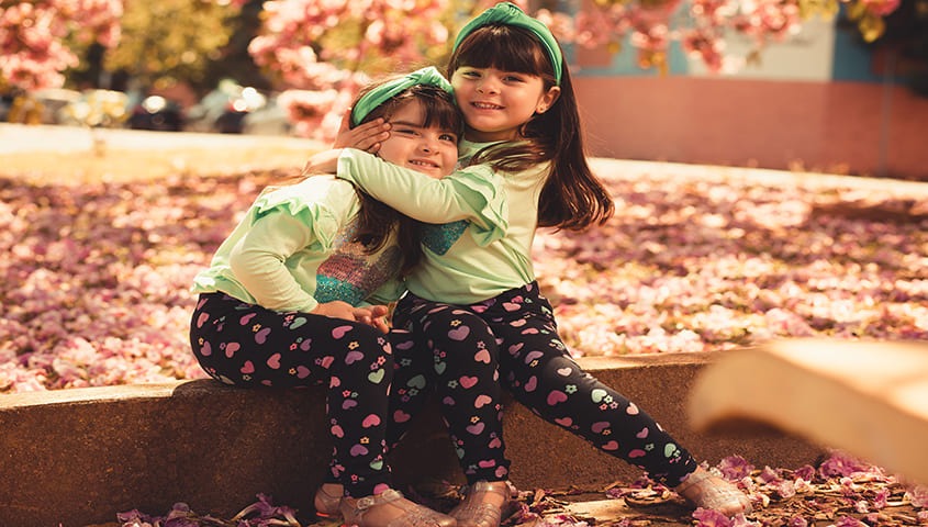 Two gril are wearing custom kid's clothing