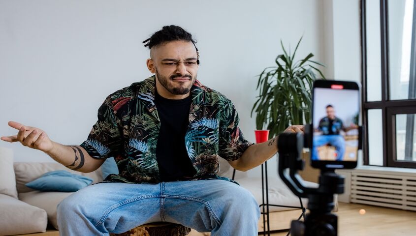 Creator filming a video review with a phone tripod, showing why affiliate marketing is one of the most compounding passive income ideas online.
