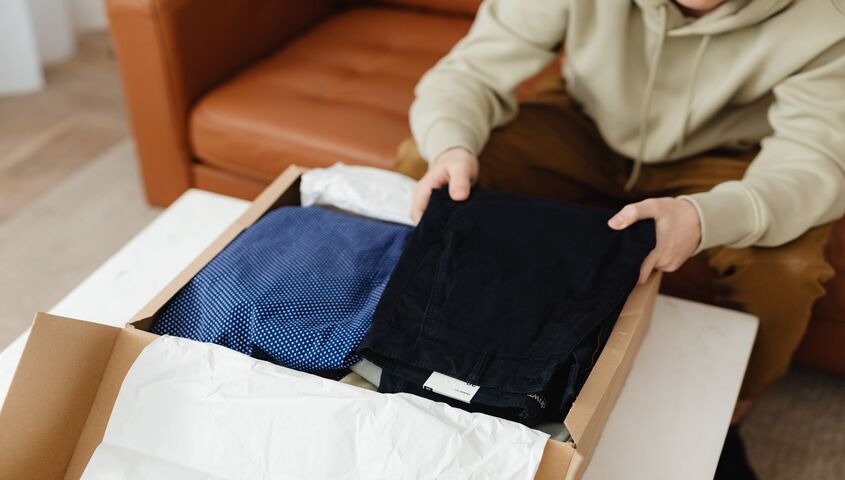 Founder unboxing a sample order in a home studio, running the numbers on is print on demand worth it before scaling up.