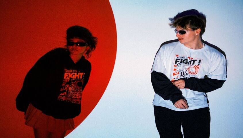 Streetwear models wearing custom-printed graphic tees, showing why Tapstitch tops the best dropshipping websites for apparel brands in 2026.