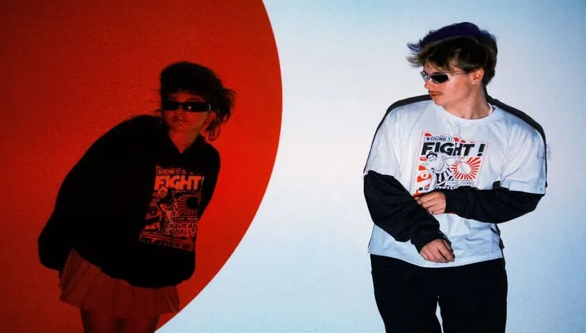 Streetwear models wearing custom-printed graphic tees, showing why Tapstitch tops the best dropshipping websites for apparel brands in 2026.