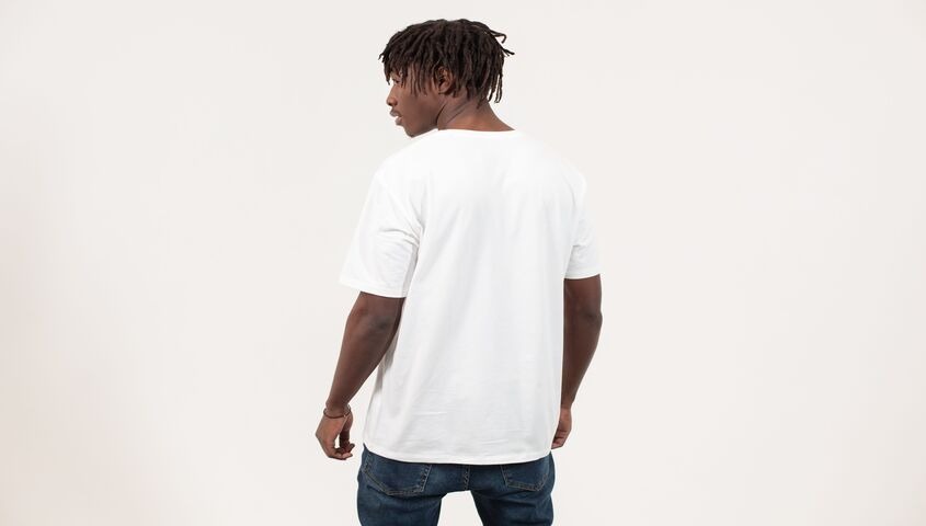 Back view of a regular-fit white tee, the neutral silhouette that makes unisex sizing work.