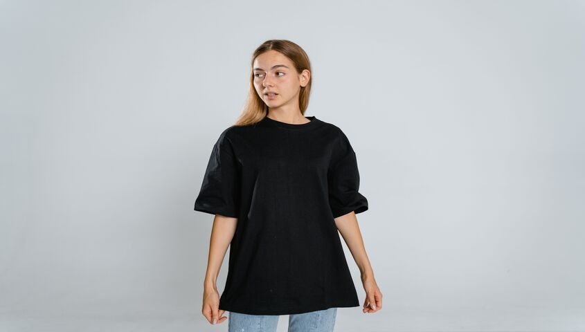Model in a heavy black oversized tee, the dense drape that separates premium from plain t shirts.