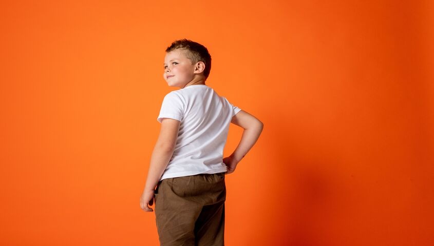 Kid in a white cotton tee, the durability test every children's blank has to pass.