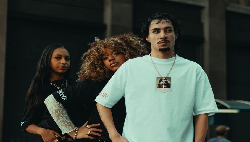 Three models in original streetwear pieces on the street, the brand ownership at the heart of what is the difference between dropshipping and print on demand.