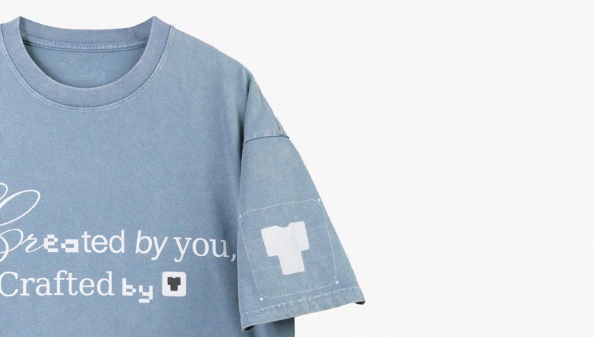 Blue T-shirt showing a chest print and a marked design area on the sleeve