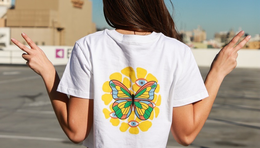 Back view of a white T-shirt showing the size and placement of a butterfly graphic
