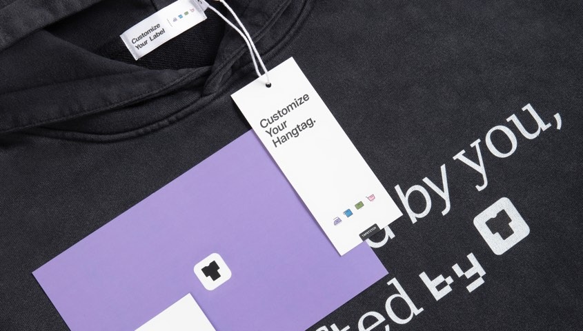 Black hoodie with a custom neck label, hangtag and insert card