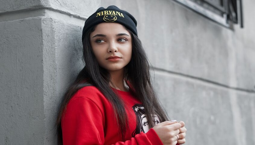 Fan wearing a band beanie with a small logo, the everyday-wear merch idea that gets worn all winter.