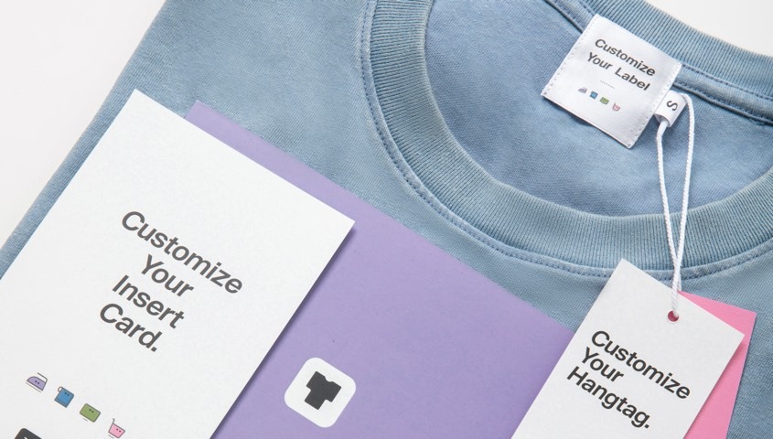 Blue garment with a custom neck label, hangtag and insert card