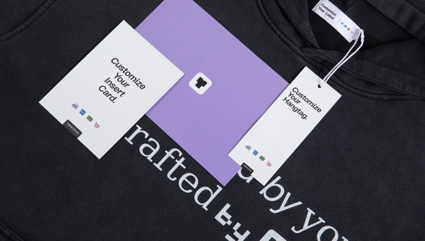 Black hoodie with a matching custom label, hangtag and insert cards