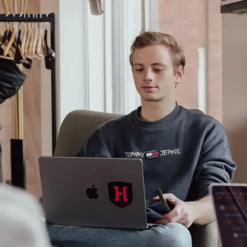A Hadrian team member working on a laptop