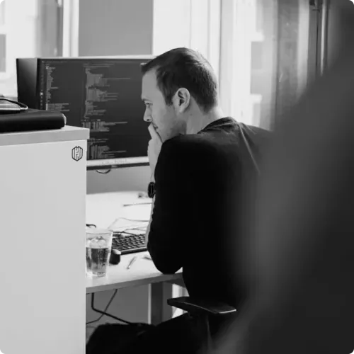 A team member of Hadrian working on cybersecurity on his computer