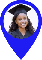 Young woman with curly hair wearing a black graduation gown and cap, smiling.